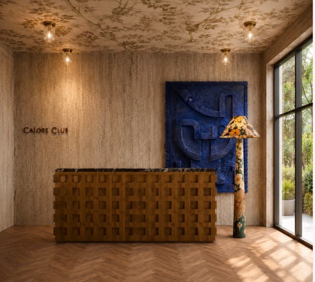 Calore Club reception with the brand signage wall